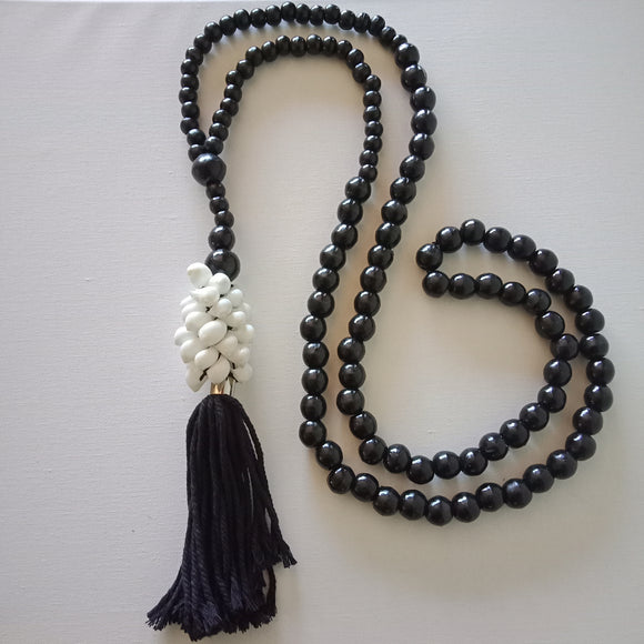 White Shells, Tassels and Black Beads.